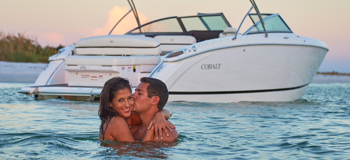 Couple Kissing in Water Behind the Cobalt R Series R7