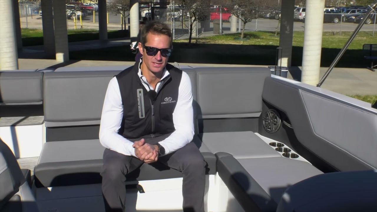 man sitting at the back of a boat talking