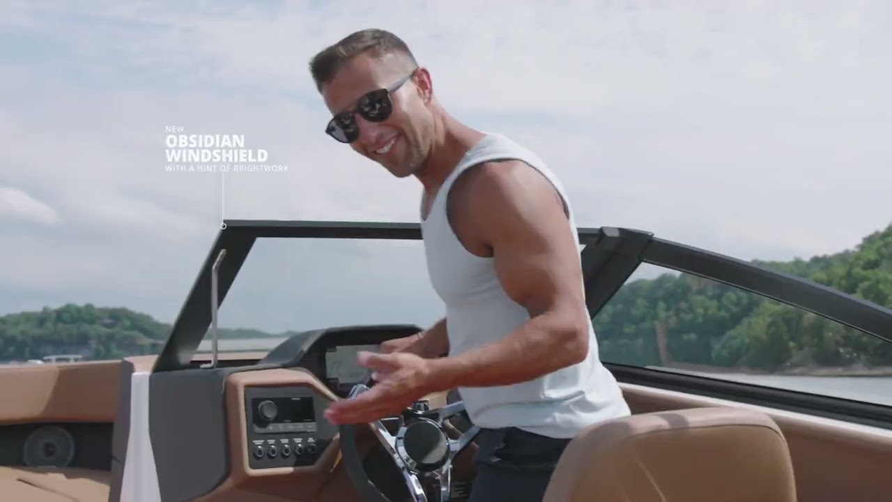 man with sunglasses driving a boat
