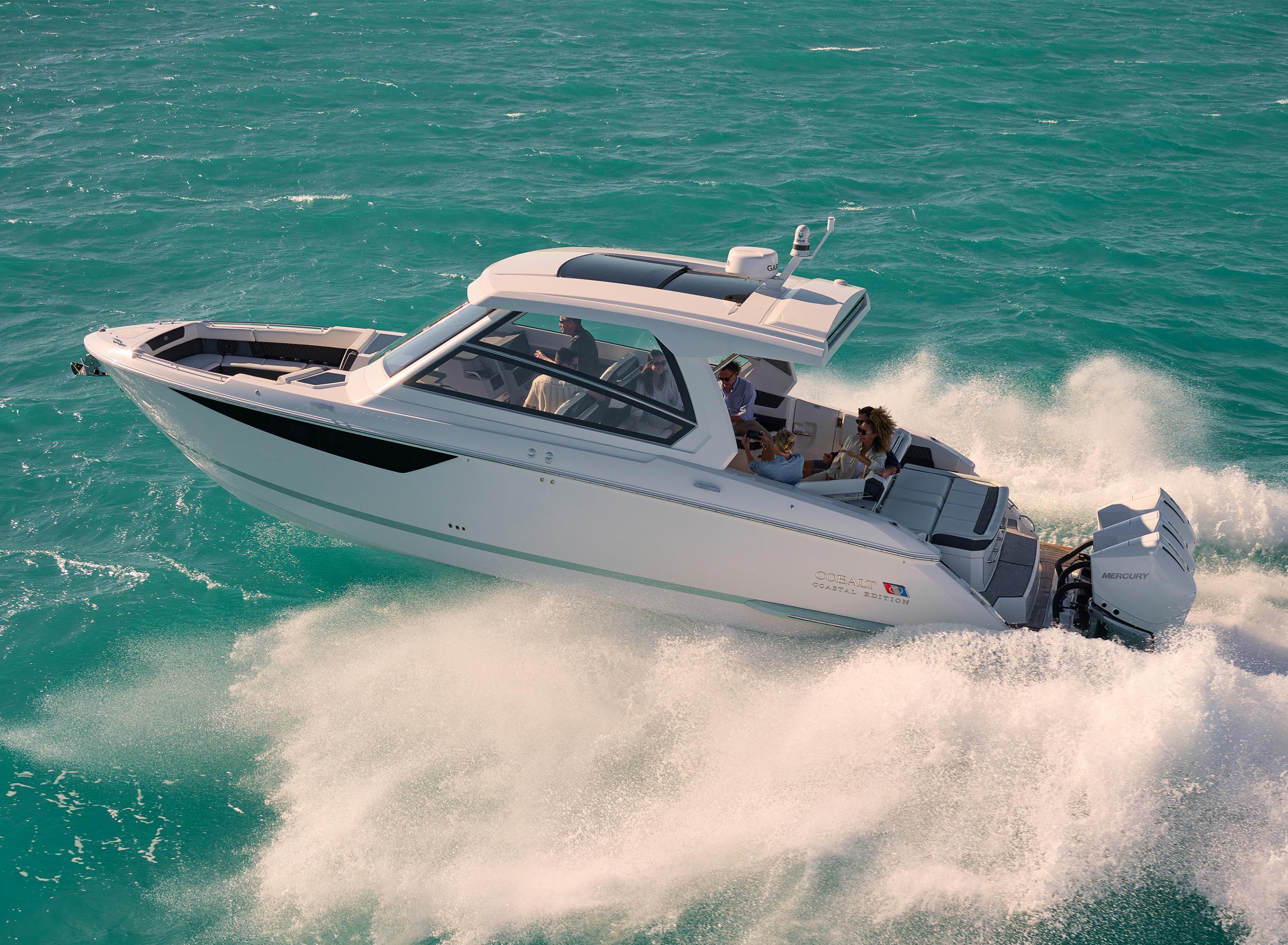 Cobalt boat cruising confidently through big open ocean waves demonstrating offshore performance and seakeeping ability