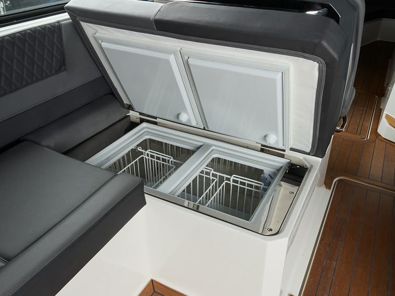 Cobalt Boats built-in deep freezer and refrigerator with open lid revealing dual wire storage baskets