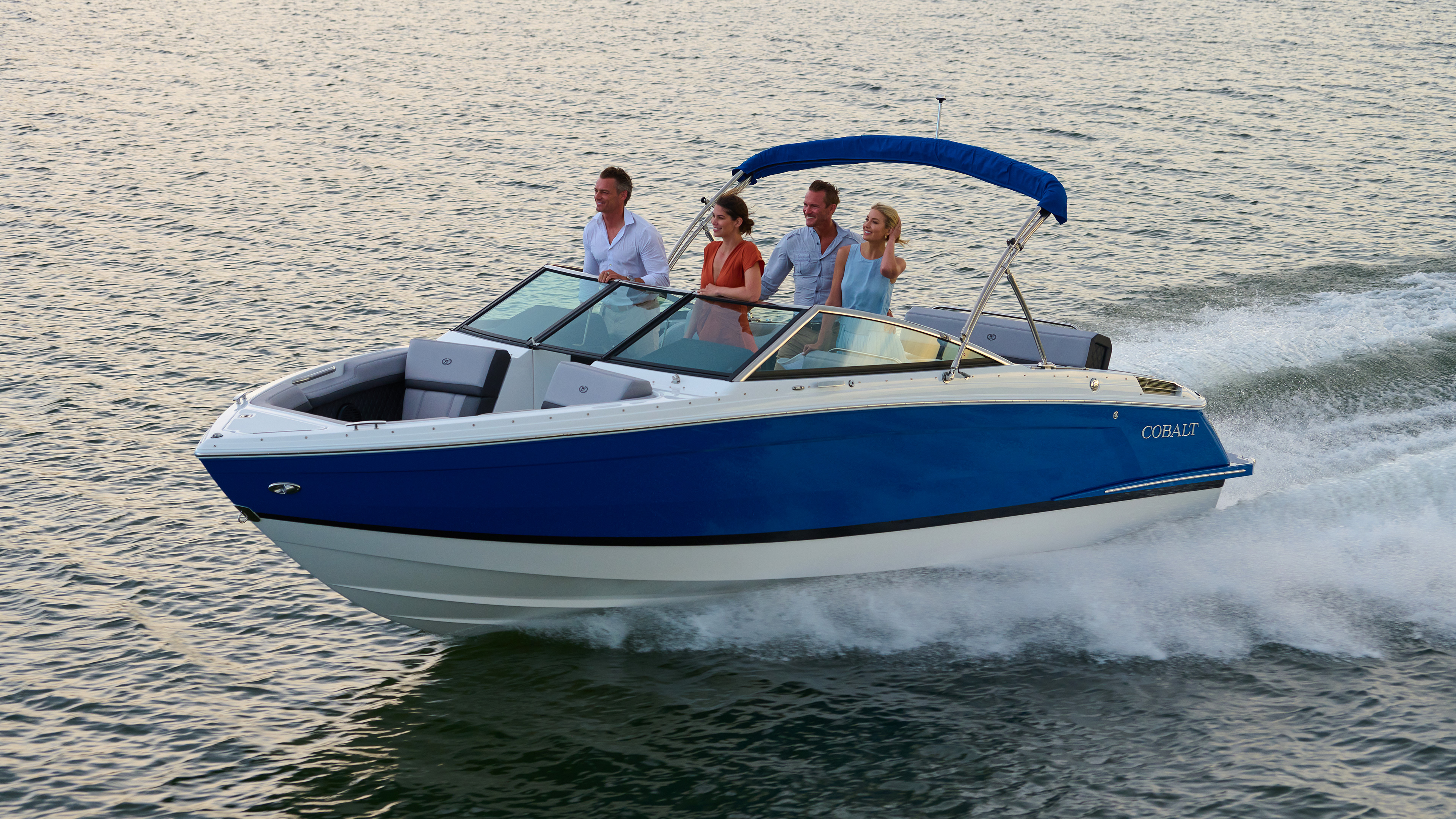 Cobalt Boats performance cruising hero desktop banner showcasing high-speed boat running on open water with dynamic bow spray