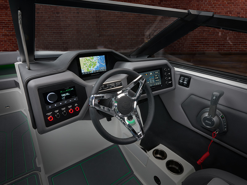 Cobalt CS23 Surf redesigned helm dash with Surf-branded steering wheel, dual Garmin touchscreens, and gray carbon-fiber styled interior