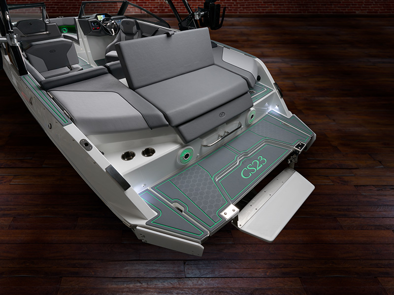 Cobalt CS23 Surf aft deck and swim step with CS23 branded grip mat, green LED accent lighting, and full interior visible in studio