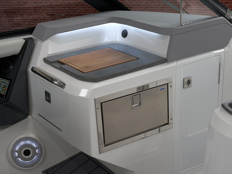Cobalt R31 Coastal prep galley featuring granite-style countertop, cutting board, and stainless refrigerator drawer