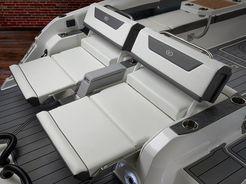 Cobalt R31 Coastal outboard expandable sunpad lounge with white upholstered seating on teak deck