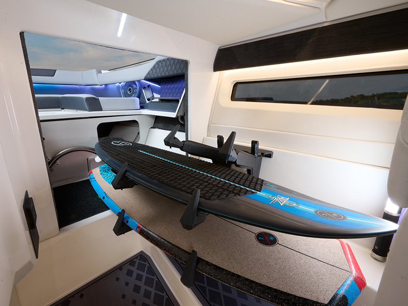 Cobalt R31 Coastal interior watersports closet with surfboard storage and ambient LED cabin lighting