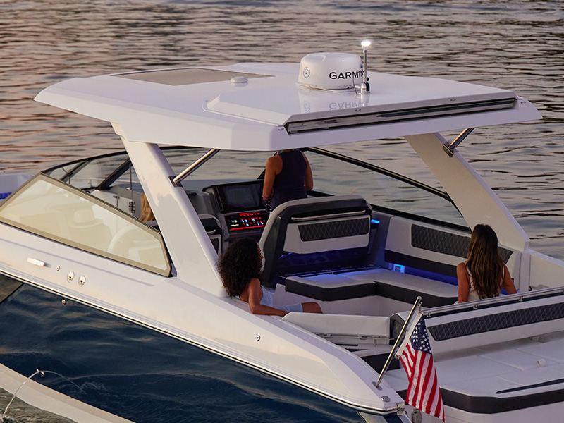 Cobalt R35 Coastal outboard arch with standard hardtop and Garmin electronics at dusk with passengers aboard