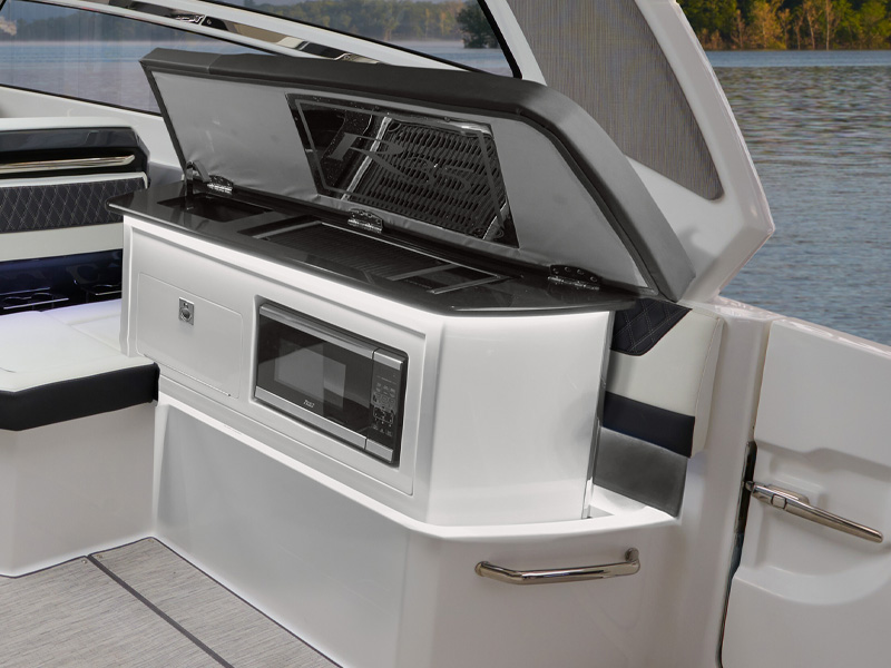 Cobalt R35 Coastal outboard autodeploy galley with built-in grill and microwave in use on open water