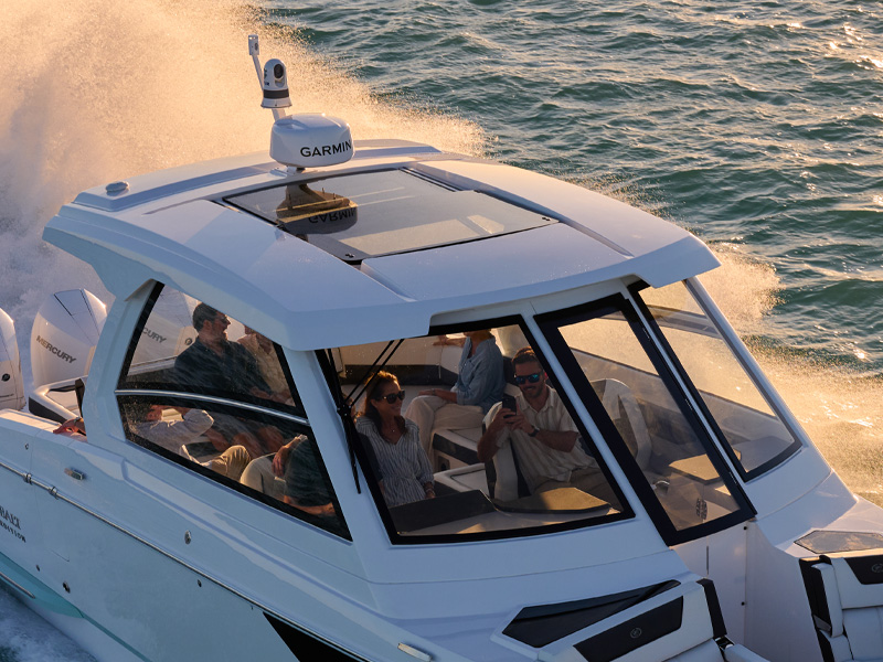 Cobalt R35 Coastal Coupe coupe top with panoramic glass roof, Garmin electronics, and passengers cruising open water