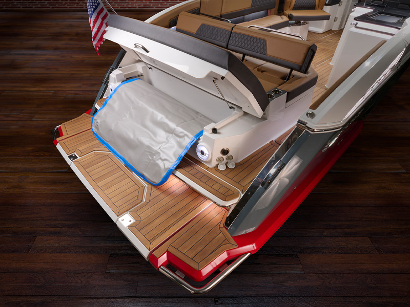 Cobalt R35 Surf aft deck Splash and Stow storage area with board bag on teak deck