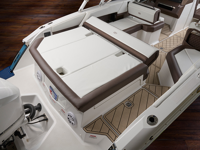 Cobalt R4 Coastal aft backrest with white and tan leather upholstery, teak-style flooring, and outboard engine visible at stern