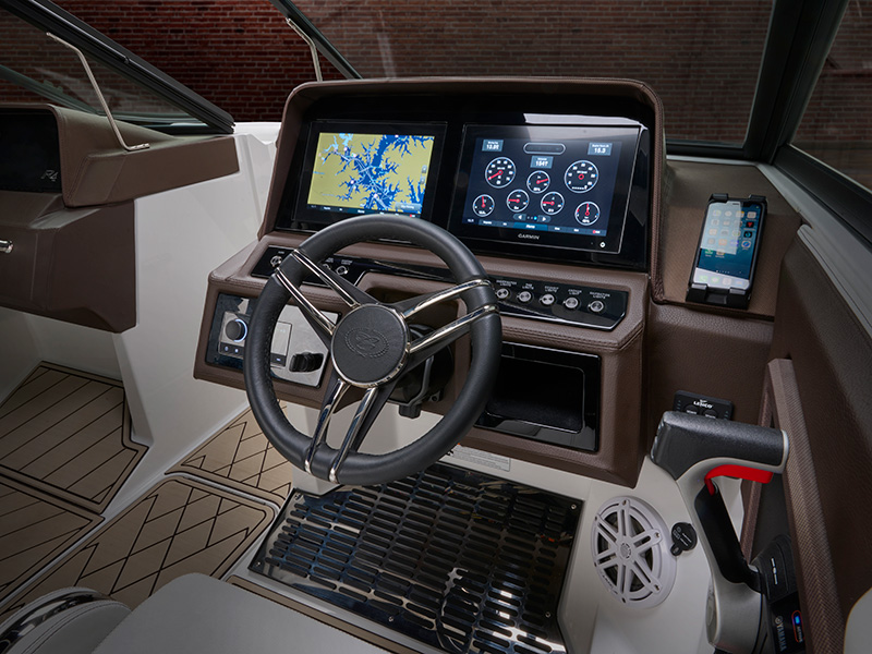 Cobalt R4 Coastal helm with dual Garmin touchscreen displays showing navigation chart and engine gauges with Cobalt steering wheel and phone mount