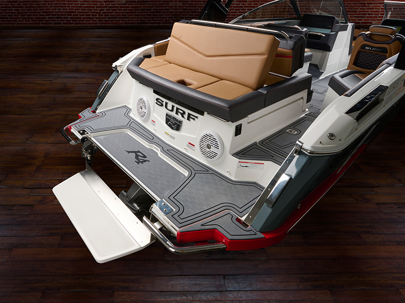 Cobalt R4 Surf electric swim step deployed with R4 branded grip mat, red hull accent, and SURF branding