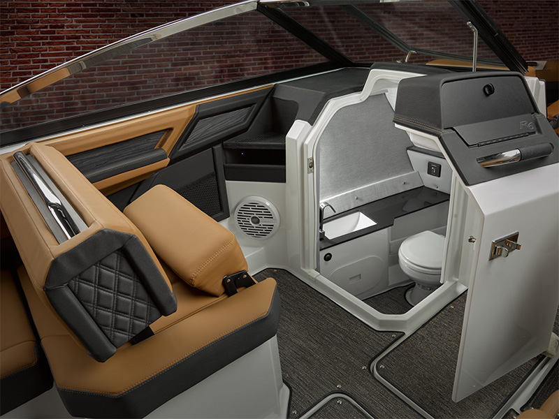 Cobalt R6 Surf head compartment with marine toilet, sink counter, faucet, and porthole window