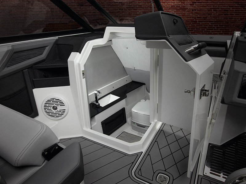 Cobalt R8 Coastal head compartment with open door revealing marine toilet and sink in white molded interior