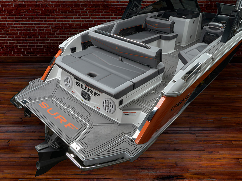 Cobalt R8 Surf aft backrest and rear seating area with gray upholstery and orange SURF branding on aft wall