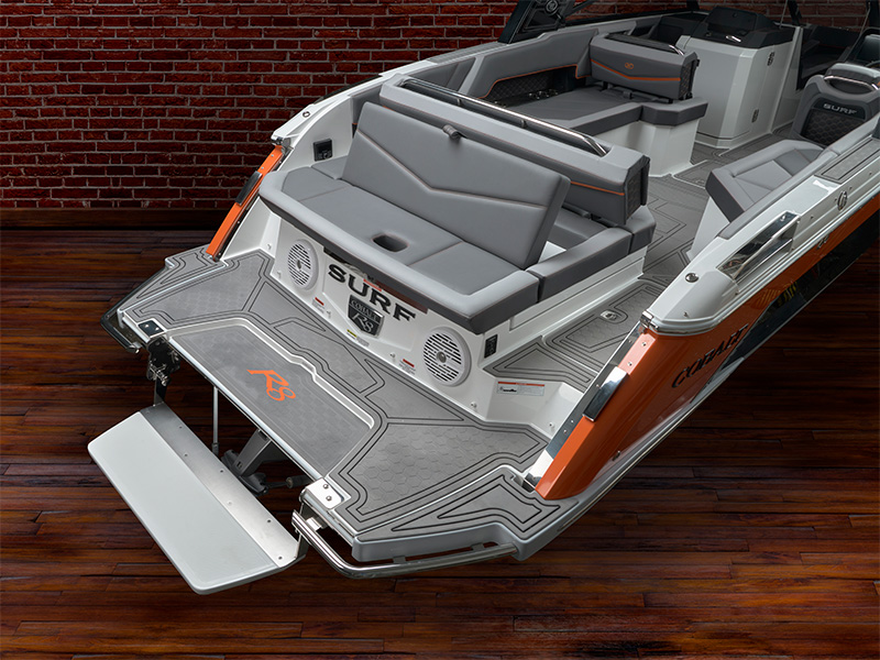 Cobalt R8 Surf swim platform and step with R8 branded gray grip mat and orange Cobalt Surf accents