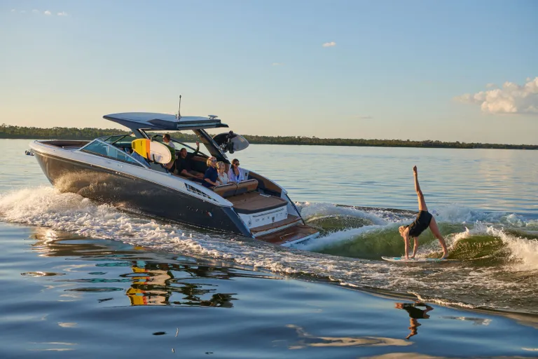 boat in water with a wakesurfer