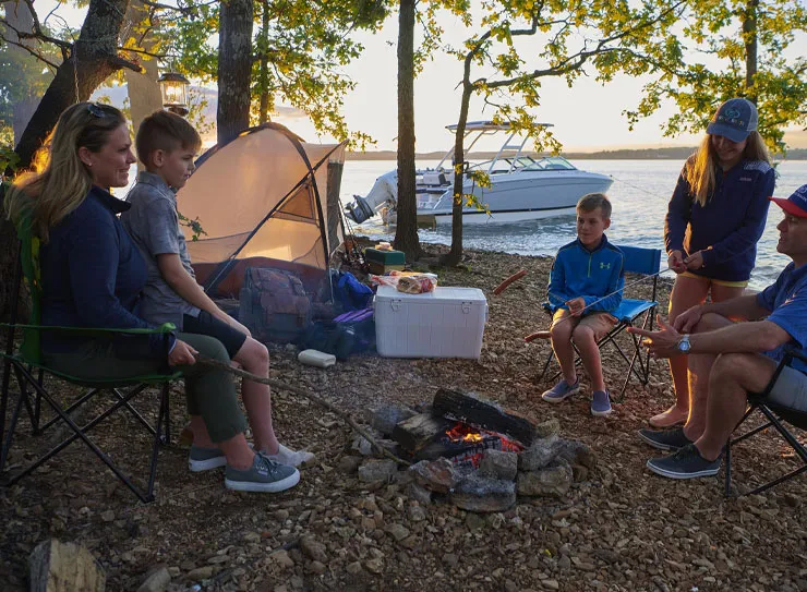 camping family boat in background