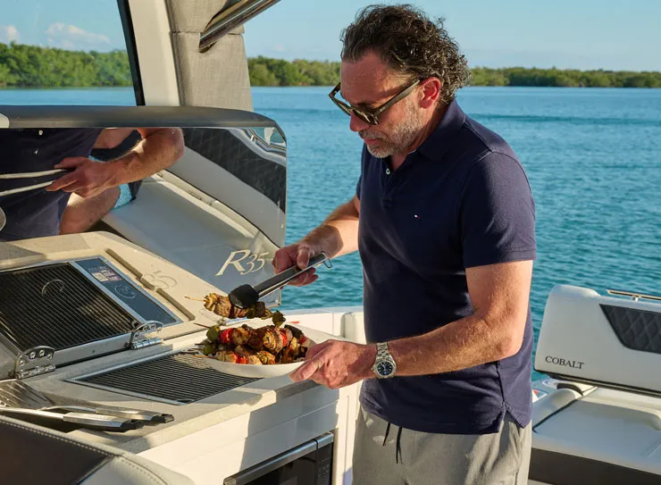 man grilling on boat