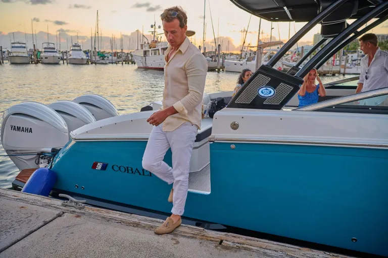 person in front of a boat on a dock