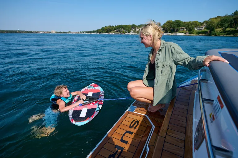 a person in water and a person in the boat