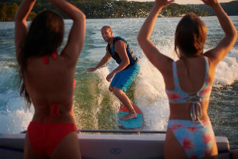 wakesurfing with 2 people watching