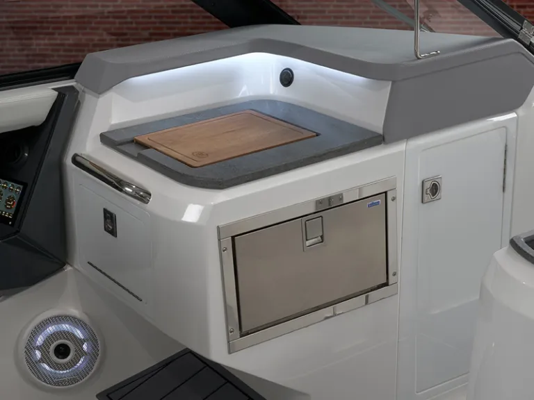 Cobalt R31 Coastal prep galley featuring granite-style countertop, cutting board, and stainless refrigerator drawer