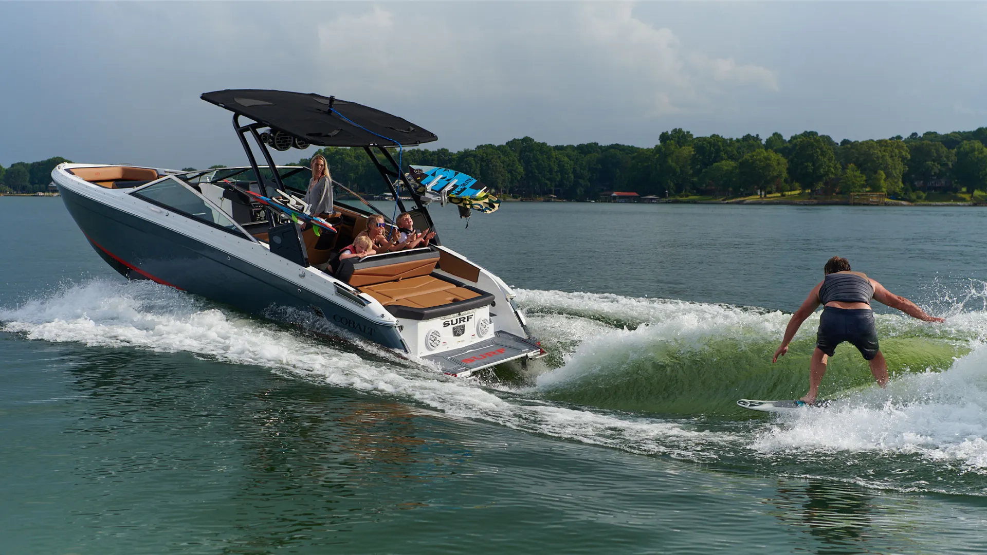 wakersurfer is surfing behind a boat