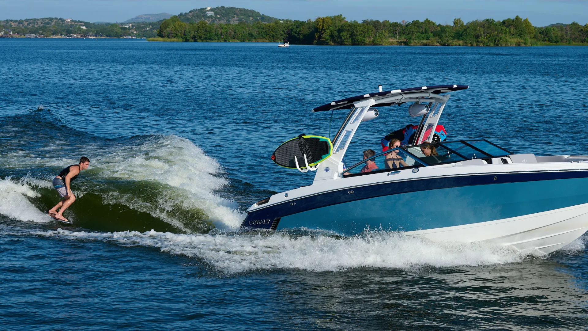 Person behind a boat surfing