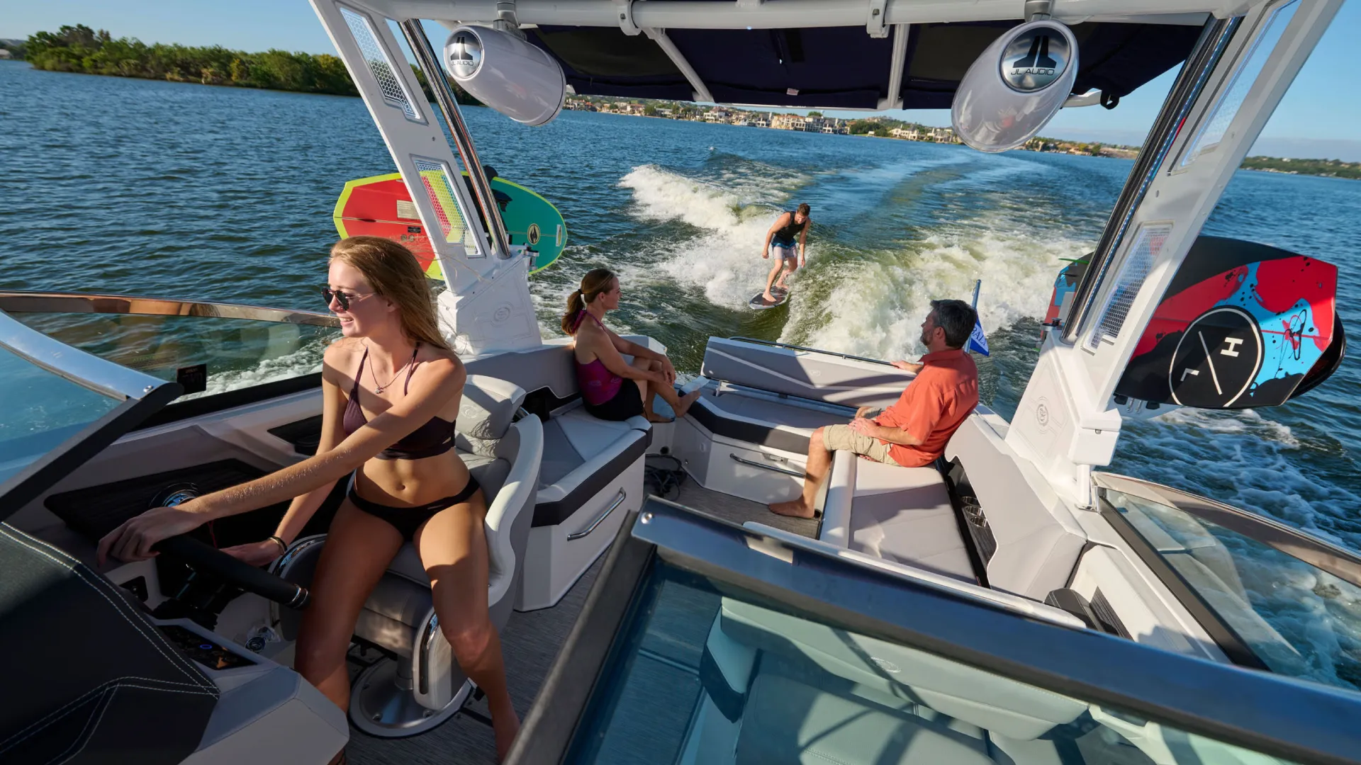 Boat driving with surfer behind