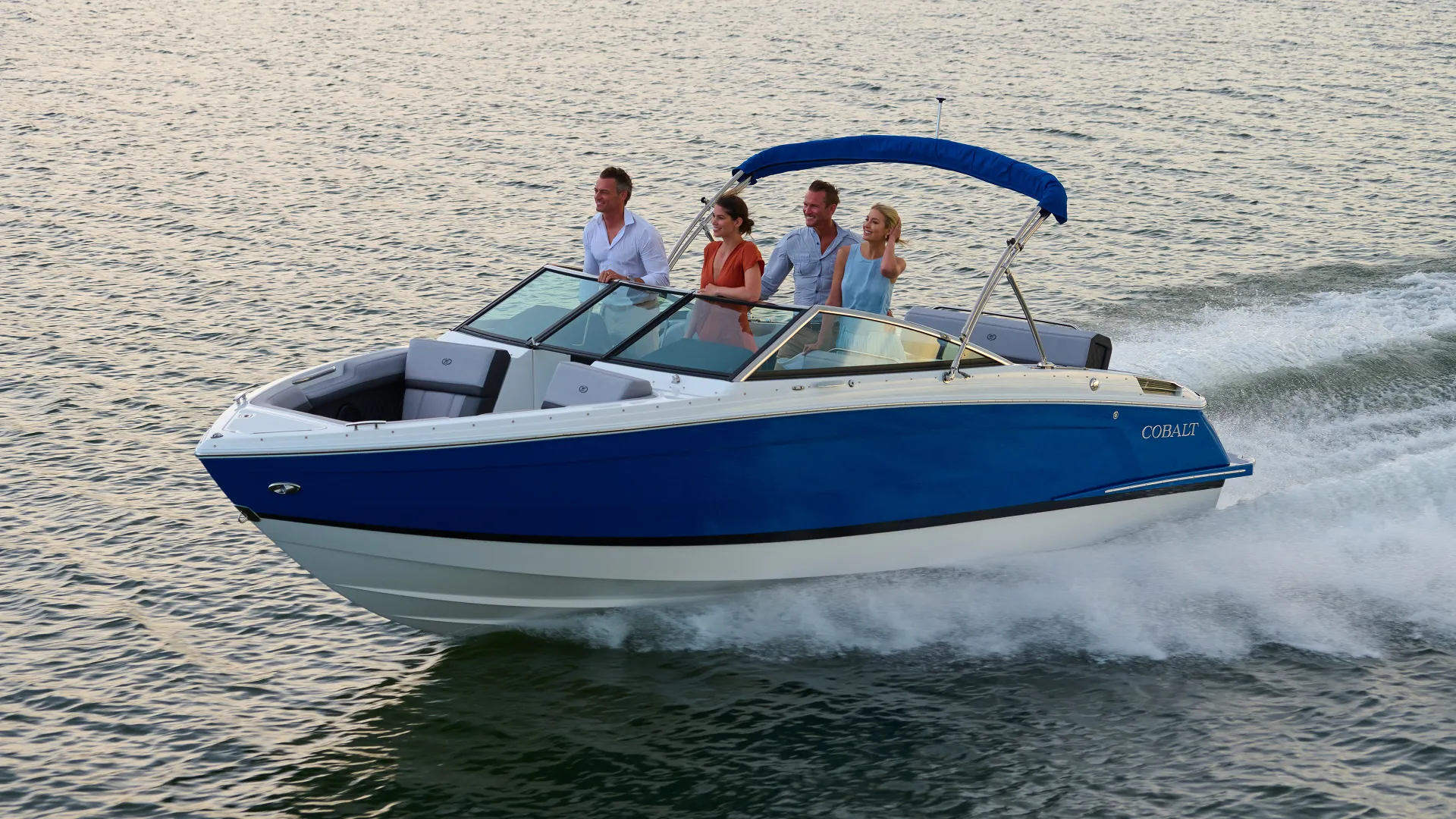 Cobalt Boats performance cruising hero desktop banner showcasing high-speed boat running on open water with dynamic bow spray