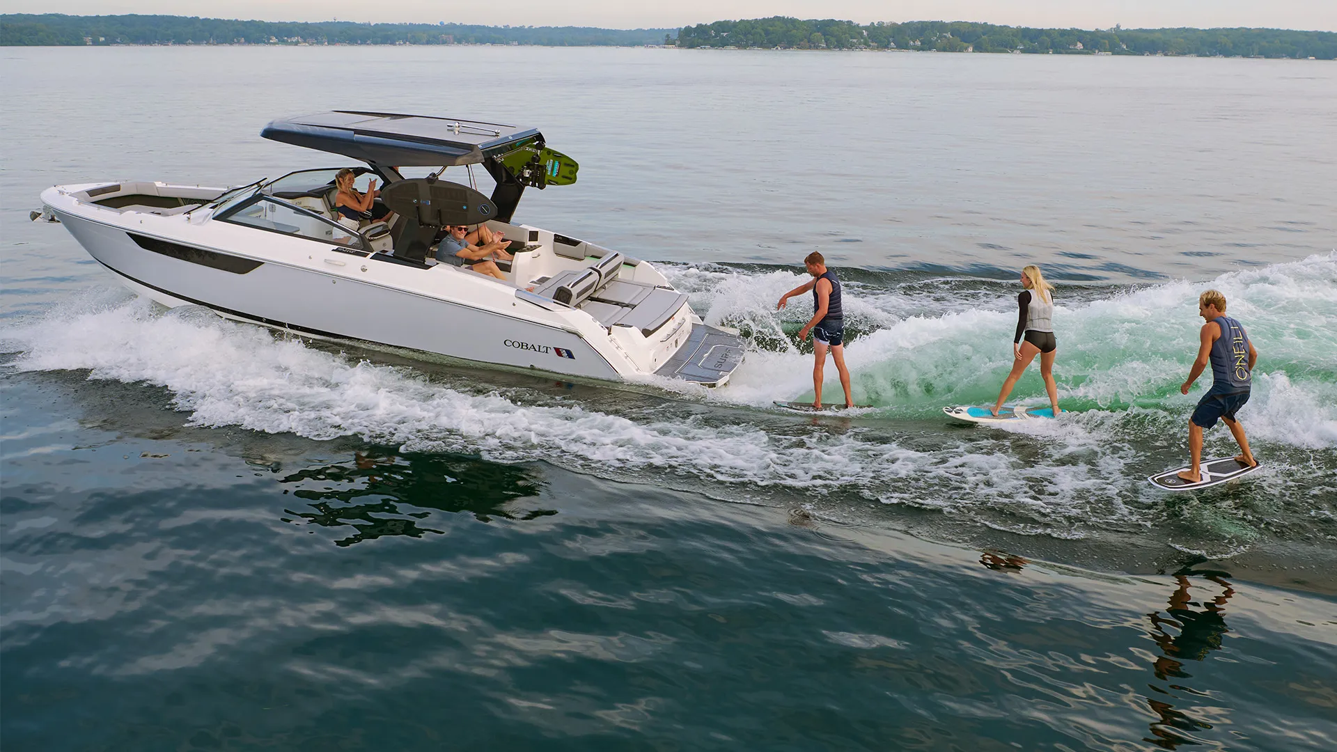 Cobalt Surf Class wake sport boats hero banner desktop view showcasing the premium surf and wake boat lineup on water