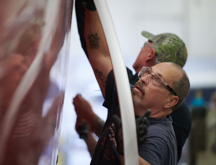 Two Cobalt Production Designers Assembling the Exterior of an R Series Boat